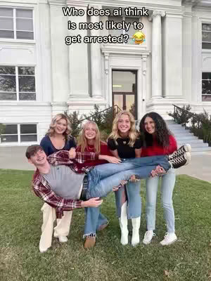 A group of five young people pose in front of a large building, with a male individual held horizontally by the others, seemingly as part of a lighthearted social media challenge; a text overlay is visible at the top of the image.
