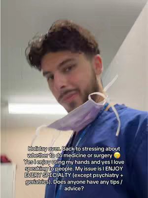 The cover image shows a young man in a medical setting, likely a medical student.  He is wearing blue scrubs, and a face mask hangs from his neck. The image is a selfie-style shot with a somewhat blurred background, suggesting a casual setting. He is looking down at the camera. Text in white is overlaid on the bottom of the image.