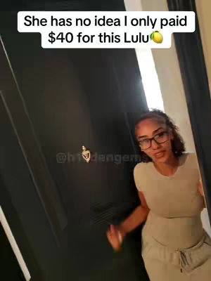 A woman with glasses and a beige outfit stands in front of a black door, peeking out from behind it. Text overlays the image.