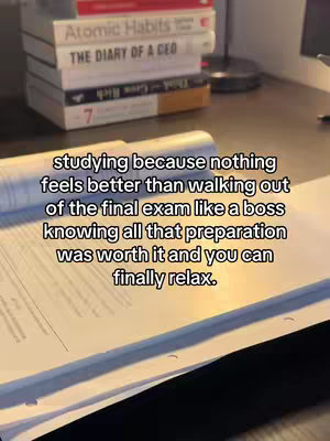 The cover image shows a desk with open books, a stack of books on the side, and a line of text overlayed on the image.