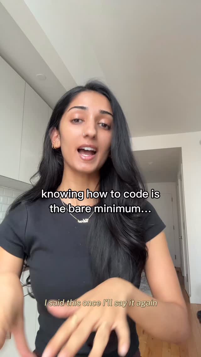 The cover image features a young woman with long, dark hair, wearing a black t-shirt. She is positioned in the center of the frame, with a neutral expression and her mouth open as if speaking. The background is a simple, bright interior with white walls and a glimpse of a tiled backsplash. Text overlays are present at the top and bottom of the image.