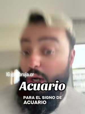The image shows a man with a blurred background, likely indoors. He has light-colored hair, a full beard with a mustache, and is looking towards the viewer. Overlayed on the image is text in bold white capitals reading 'Acuario', followed by the phrase 'PARA EL SIGNO DE ACUARIO'.