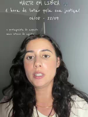 A woman with dark curly hair is centered in the frame, looking slightly upward with a composed expression. Overlayed text in ornate white font is prominently displayed at the top, against a grey background.