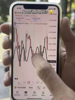 A close-up shot of a smartphone displaying a trading chart with a highlighted line, held by a hand with a finger touching the screen. The chart shows green and red bars on a black background, with numerical scales on the right side. The phone's screen also has a white overlay with text that reads "Don't do this."