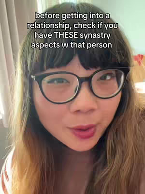 A selfie-style shot featuring a woman with long, light-brown hair, black-framed glasses, and red lipstick. Text overlayed on the image advises the viewer. The background is softly lit with a neutral tone, and the woman directly faces the camera with a slightly pursed expression.