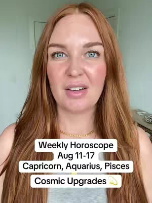 A medium shot features a fair-skinned woman with long, auburn hair, and blue eyes. She is center frame, looking directly at the viewer with a slight smile. Overlaid on the image is a white rectangle with black text detailing the weekly horoscope for the zodiac signs Capricorn, Aquarius, and Pisces. The background consists of a light-colored interior setting.