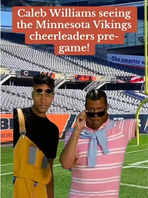 Two men in front of a football stadium. The left figure is wearing yellow overalls, a black shirt, and dark sunglasses. The right figure is wearing a pink and white striped shirt with a blue sweater draped over their shoulders, and dark sunglasses, leaning up to adjust them. Text overlayed at the top states 'Caleb Williams seeing the Minnesota Vikings cheerleaders pre-game!'