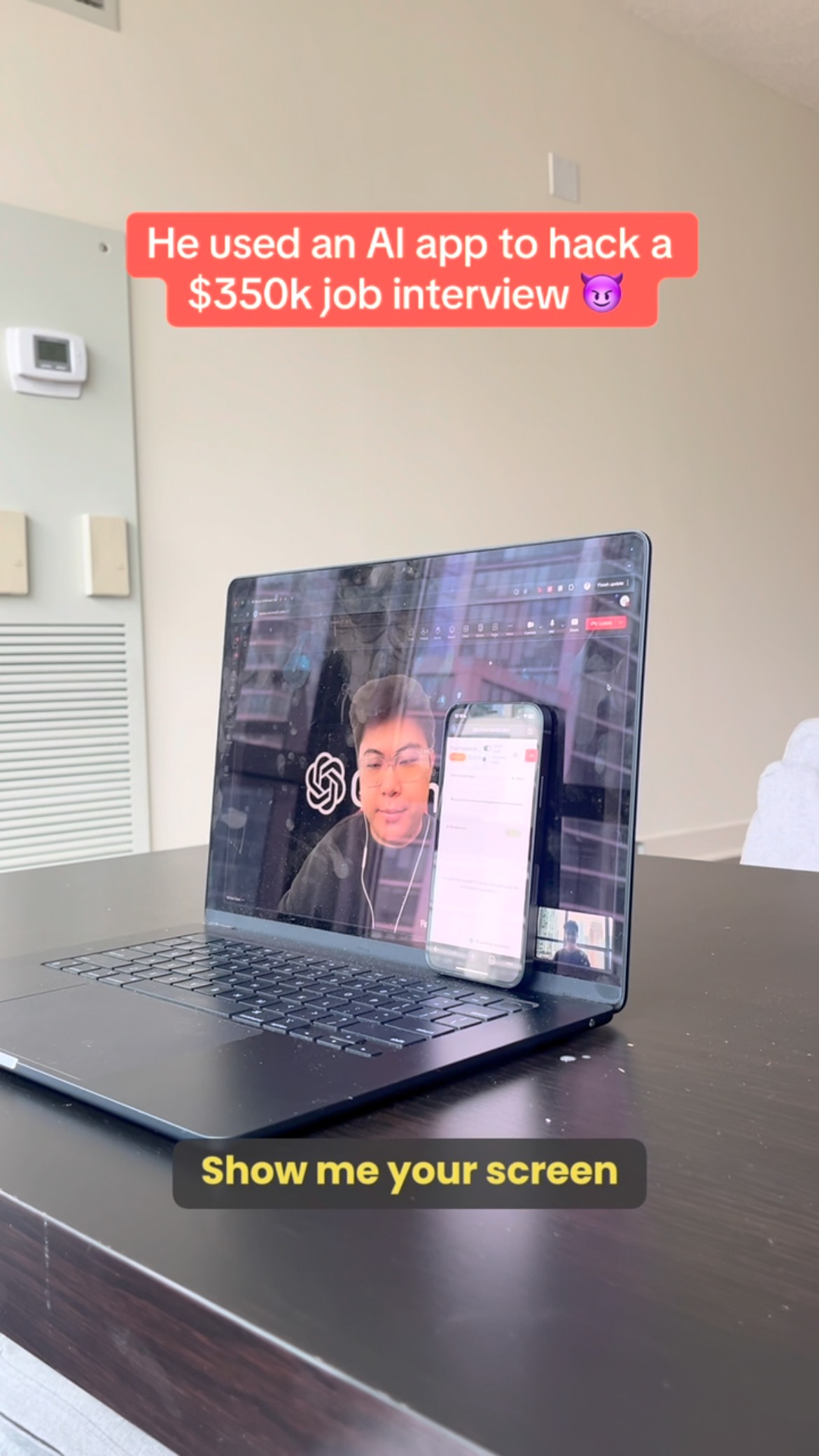 A laptop displaying a video call with a person on the screen, a phone is standing next to the laptop, with text overlays advertising a AI app to hack a job interview.