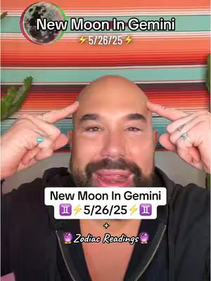 A bald man with a beard is centered, pointing fingers towards his head. A background of striped orange, red, and teal fabric is present. Overlaid text declares 'New Moon In Gemini 5/26/25'. Below, text reads '+ Zodiac Readings' with purple accents. A graphic of the moon is in the top left.
