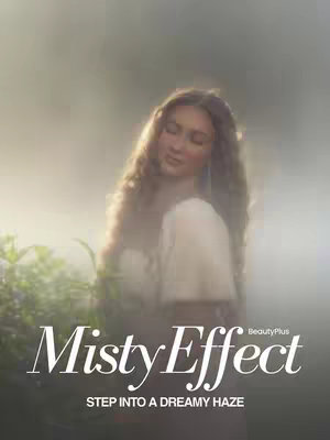 The image features a woman with long, wavy hair, standing in a misty environment. She wears a light-colored top. The background is blurred with a soft, ethereal effect, with muted green and grey tones suggesting a forest or outdoor setting.