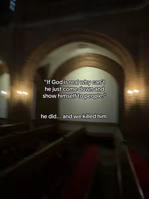 An indoor, medium shot captures a church interior with an arched ceiling and rows of pews. The image is dimly lit, with warm, amber light emanating from unseen sources, emphasizing the structural details. Text is overlaid, using a simple white font, against the darker background. The composition suggests a sense of history and contemplation.