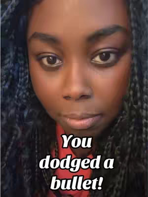 A close-up of a Black woman's face, framed in a medium shot. She has dark skin, dark eyes, and dark, braided hair framing her face. The lighting appears soft and even, highlighting her features. Overlayed on the image is white text with a bold font.