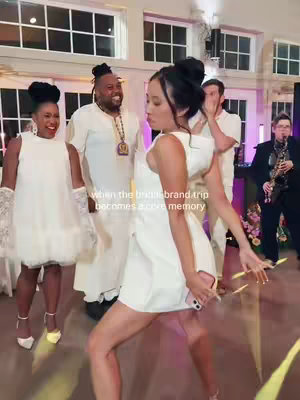 The cover image shows a group of people at a wedding reception, with a woman in a white dress dancing in the foreground. The woman is in a dynamic pose, mid-dance move. Other people are visible in the background, in various states of reaction. Text overlay indicates this is a 'brand trip' memory.