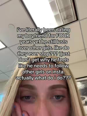 A selfie-style video cover featuring a close-up of a young woman's face. She has blonde hair and is looking downwards with a concerned expression. Text is overlaid on the image, detailing her relationship issues.