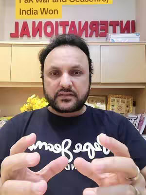 The cover features a man with a dark beard, wearing a navy shirt with white text. The background has wooden cabinets with the word INTERNATIONAL on a red sign.