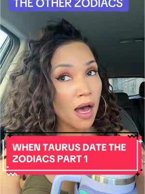 A woman with curly brown hair, makeup, and large hoop earrings is in the front seat of a car. The top of a blue box and the vehicle's interior are visible. A red bar with white text and a blue bar with white text are on the image. The bars display astrological information: