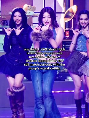 The cover image showcases three young women on what appears to be a stage or studio with a background of stage elements and ambient lighting. The women, dressed in stylish outfits, are arranged in a triangular composition. Each woman is mid-gesture, with one pointing upwards. Text overlays the image with a description of the image.