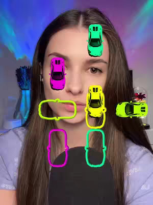 A selfie-style shot of a woman with long, dark hair, a light purple shirt, and a partially visible microphone. Overlayed on her face are several stylized illustrations of toy cars and car-shaped outlines. The background includes a bokeh effect of purple and blue colors.