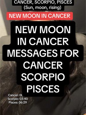 The image features a partially visible person in the background with a rectangular overlay in the center. The overlay is black with white text detailing astrological information about the new moon. Text at the top indicates the signs Cancer, Scorpio, and Pisces. Below, the phrase "NEW MOON IN CANCER" is highlighted in a red box. Below, in a descending order on different lines of the overlay, the message reads, “NEW MOON IN CANCER MESSAGES FOR CANCER SCORPIO PISCES”. The bottom of the image has additional text: "Cancer: 0", “Scorpio: 03:40”, “Pisces: 06:29”.