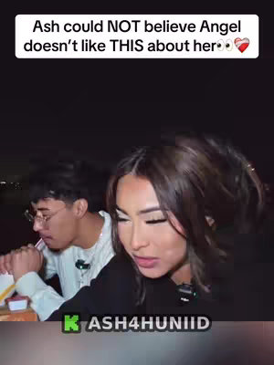 A selfie-style shot featuring a young woman in the foreground with another person partially visible in the background. The main subject is looking down, with a serious expression. They are in what appears to be a casual outdoor setting, possibly at night. Text overlay at the top provides context to the shot.