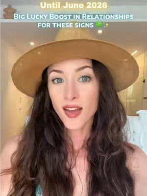 A woman with long brown hair and fair skin is the focus of the image, wearing a tan sun hat and looking directly at the camera.