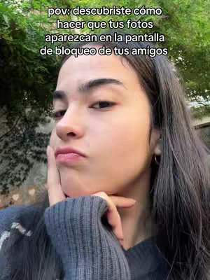A selfie image of a young woman with a slightly whimsical expression, hair to one side, against a blurred outdoor background. Text overlay at the top explains how to have photos appear on friends' lock screens.
