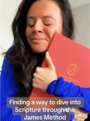 The cover image shows a woman with dark hair in a blue top holding a closed red book, appearing to hug it. She has her eyes closed and is smiling. The book is on her right side and she seems to be embracing it. Text overlay at the bottom says, 'Finding a way to dive into Scripture through the James Method'. The background is plain and light-colored.