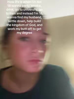 A softly blurred image of a person's face, predominantly in pink and black hues, is overlaid with text.  The person appears to be in their late teens, with dark attire against a beige backdrop, creating a somewhat intimate feel despite the blur.