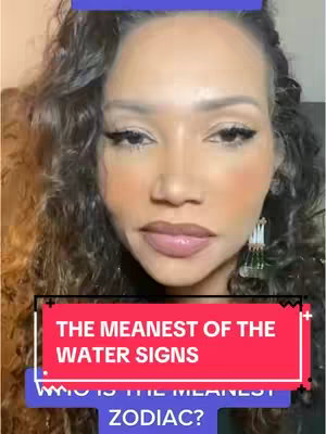 A woman with curly hair is shown in a close-up shot, set against a blurry background. She has prominent makeup with dark eyeliner, blush, and lipstick. Overlay text in red and blue boxes states "THE MEANEST OF THE WATER SIGNS" and "WHO IS THE MEANEST ZODIAC?"