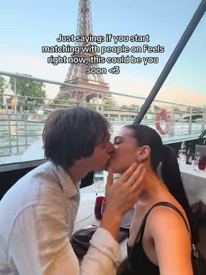 A couple kissing passionately on a boat, with the Eiffel Tower in the background. Text overlayed on the image encourages viewers to start matching on the Feels app. The setting appears to be a romantic location.