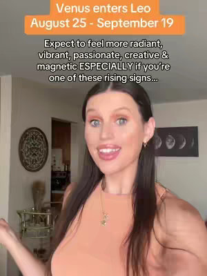 A woman with long dark hair and a coral-colored top is smiling and facing slightly to the side. Overlay text in an orange box at the top details astrology information. The background includes blurred decor and objects in the room.