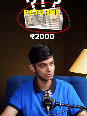 The cover image has a man sitting. Above him is text inside a red circle that says returns with a stack of cash. Below that is the text 2000. The background is is blurred, and the man wears a blue polo shirt. He is sitting at a desk with light to his right, and a microphone on a stand in front of him.