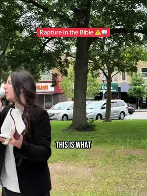 A woman in a black blazer stands in front of a somewhat blurry outdoor setting. The background features green trees and foliage, with buildings, parked cars, and a grassy area visible. Text overlays provide additional context, including a red banner that has the text, "Rapture in the Bible" in white letters, and a black text box on the bottom with the text, "THIS IS WHAT".