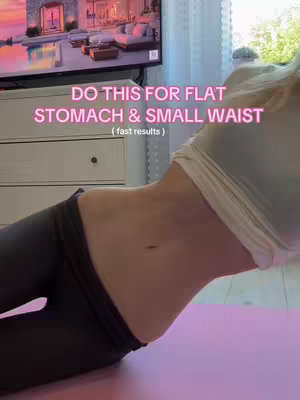The cover image shows a woman working out, likely doing a core exercise. The main focus is on her torso and midsection, which is toned, with emphasis on abs and small waist. The background shows a TV and dresser, suggesting it's an indoor workout.