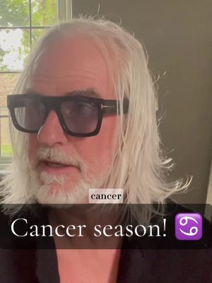 A man wearing glasses with dark frames is in the shot. He has white hair and beard. Hook text is on the bottom: 'Cancer season!' with a purple cancer zodiac sign.