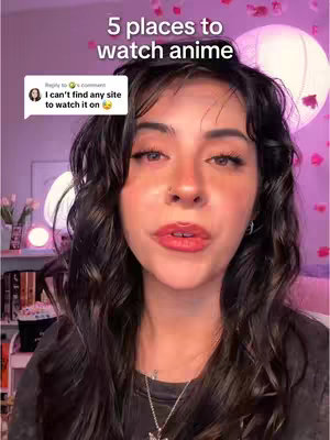 A medium shot of a young woman with curly dark hair, light skin, and full red lips. She is looking towards the viewer with a slight smile, and her dark eyes are visible. A speech bubble with text is overlaid on the screen. The background is softly lit with pink and white tones.