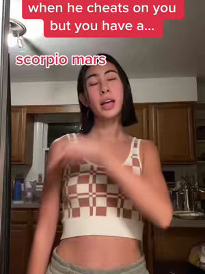The cover image shows a young woman in a kitchen setting. Above her head is a red banner with white text and below her head is a pink banner with white text. She is the central focus, wearing a patterned crop top and looking slightly to the side. Brown cabinets are visible in the background.