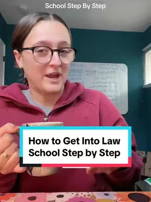 A young woman with glasses is holding a coffee cup and smiling while looking directly at the camera. She is wearing a burgundy hooded sweatshirt. Below her is a teal and white graphic with the video title. Behind her are blurred elements, including a whiteboard, and another portion of the room. The background has a teal wall.