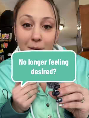 The cover image features a woman in a green hoodie, with her face close to the camera. A turquoise speech bubble overlay displays the text "No longer feeling desired?". Her hands are visible, one holding a microphone and the other displaying a ring and dark nail polish.