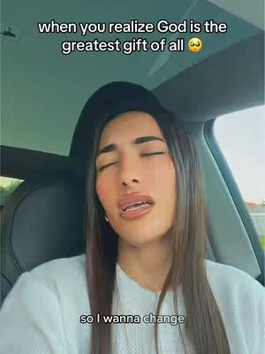 A woman with long brown hair is inside a car, looking upwards with her eyes closed. Text overlays appear at the top and bottom of the image.