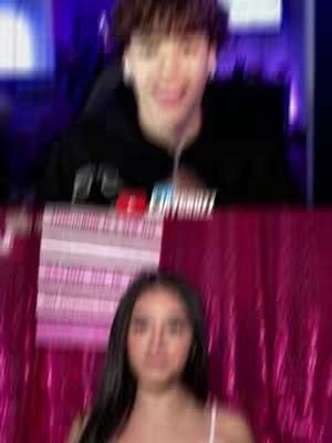 The cover image is divided into two vertical halves. The top shows a blurry image of a person with brown hair, wearing a black top. Below, the image shows a young woman with long black hair against a pink, glittery background.