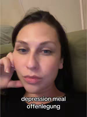 A medium shot shows a young woman looking at the camera with a slight tilt of her head. She has dark hair and is wearing a black top. Overlayed at the bottom is text in white font.