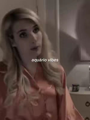 The cover image features a woman with blonde hair in a room. The hook text 'aquário vibes' is overlaid. The overall composition is soft, in tones of light brown and pink.