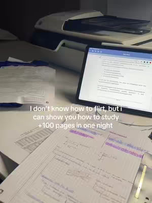 A workspace is shown with a tablet displaying text, papers with hand-written notes, and a printer in the background. The text overlay reads "I don't know how to flirt, but I can show you how to study +100 pages in one night."