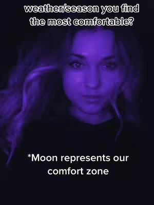 A woman's face is centered in the frame, illuminated with a purple hue. The background is dark, emphasizing the highlighted features. Overlayed text asks a question about comfort in weather or seasons, with additional text clarifying the moon's symbolic meaning within a comfort zone.