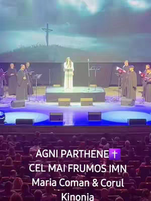 A cover image from a concert featuring a stage with a group of people, a choir, and a backdrop of a sky with a cross.