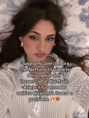 A woman with dark hair is lying on a bed, looking up at the camera. Text overlays the image, providing commentary on astrology.