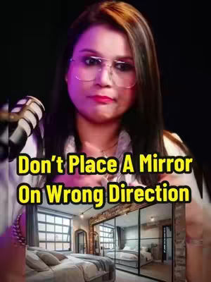 The cover image features a woman wearing glasses against a blurred black background. The text overlay reads "Don’t Place A Mirror On Wrong Direction". Below the text is a view of a modern bedroom with a large mirror reflecting the room's interior.