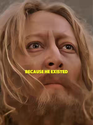 Close-up shot of a man with long, light-colored hair and a beard. The man has a serious expression, and the text overlayed reads 'BECAUSE HE EXISTED' in yellow.