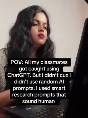 A young woman with long, dark hair and lipstick sits in front of a laptop, looking down at the screen. She is wearing a knitted top. Overlaid on the image is a bold, black rectangular textbox containing white text that appears to be a point-of-view statement and explanation of her use of smart, research-based prompts for ChatGPT.